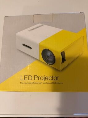 New never used Compact LED Projector in White and Yellow